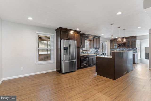 1762 Red Oak Ln, Waldorf, MD 20601 - kitchen with stainless steel fridge with ice dispenser, glass insert cabinets, tasteful backsplash, dark brown cabinets, and wood finished floors
