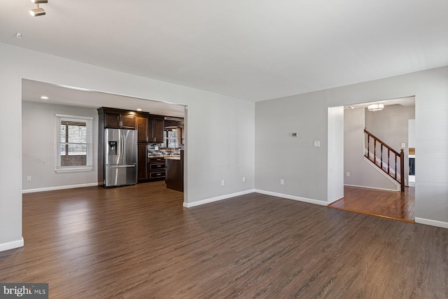 1762 Red Oak Ln, Waldorf, MD 20601 - unfurnished living room with baseboards, an inviting chandelier, recessed lighting, stairway, and dark wood-type flooring
