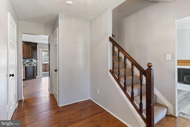 1762 Red Oak Ln, Waldorf, MD 20601 - stairway with a textured ceiling, baseboards, and hardwood / wood-style flooring