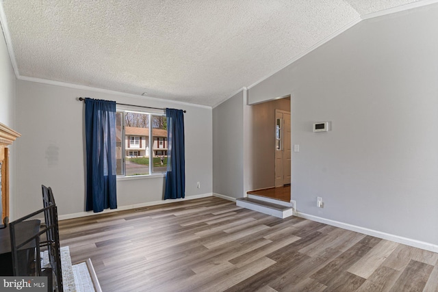 1762 Red Oak Ln, Waldorf, MD 20601 - unfurnished living room featuring ornamental molding, a textured ceiling, wood finished floors, and lofted ceiling