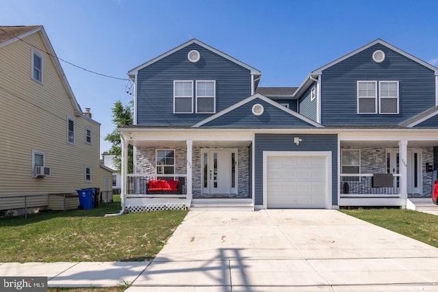 front facade featuring a garage, covered porch, and a front yard