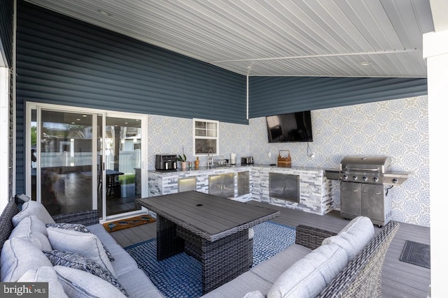 view of patio / terrace featuring area for grilling, an outdoor living space with a fireplace, and exterior kitchen