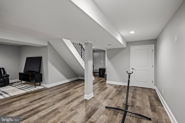 basement with hardwood / wood-style flooring