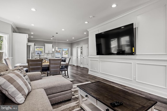 living room with ornamental molding and dark hardwood / wood-style floors