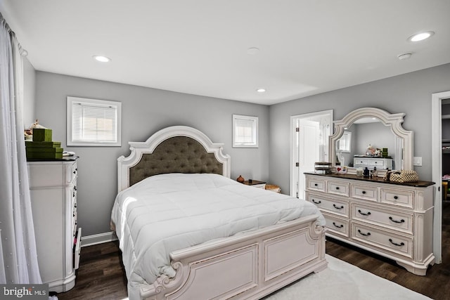 bedroom featuring multiple windows and dark wood-type flooring