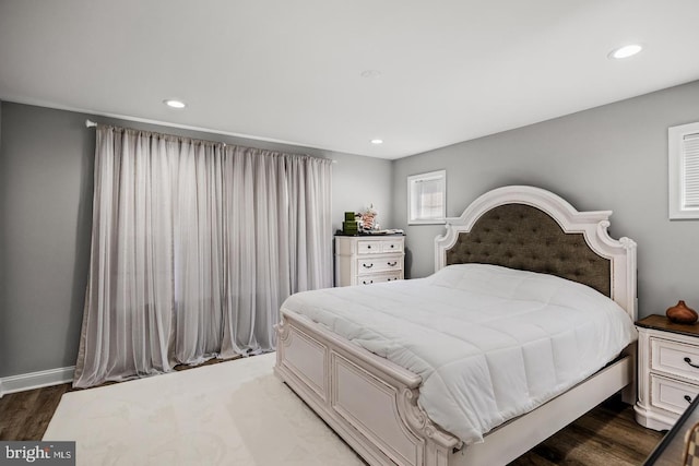 bedroom with dark hardwood / wood-style flooring