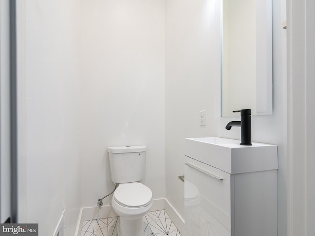 bathroom with vanity, toilet, and tile patterned flooring