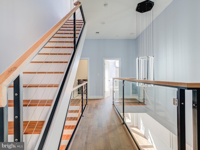 staircase with wood-type flooring