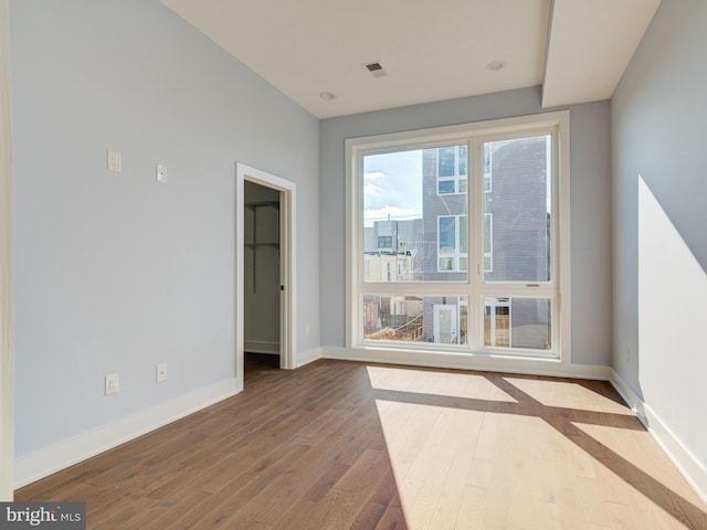 empty room with hardwood / wood-style flooring