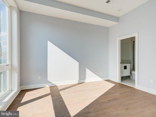 spare room featuring wood-type flooring