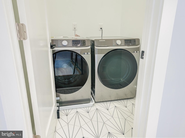 washroom with tile patterned floors and independent washer and dryer