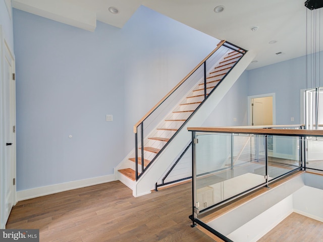 staircase featuring hardwood / wood-style flooring