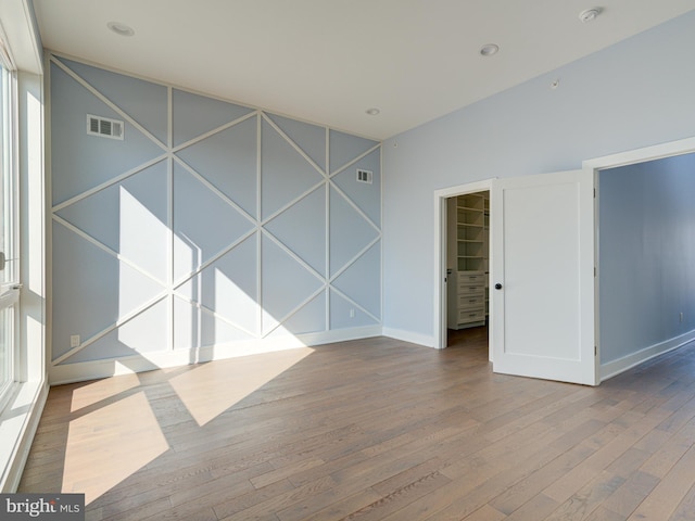 unfurnished room with wood-type flooring