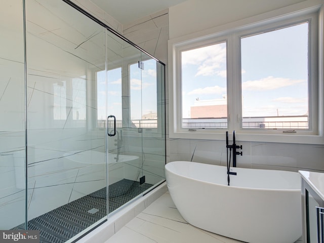 bathroom with shower with separate bathtub