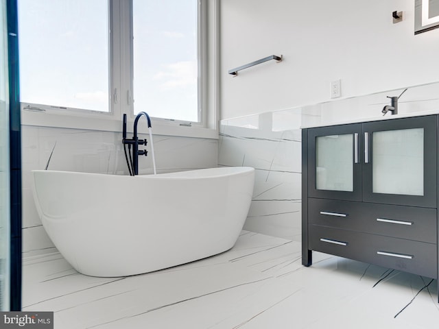 bathroom with a bathtub and tile walls