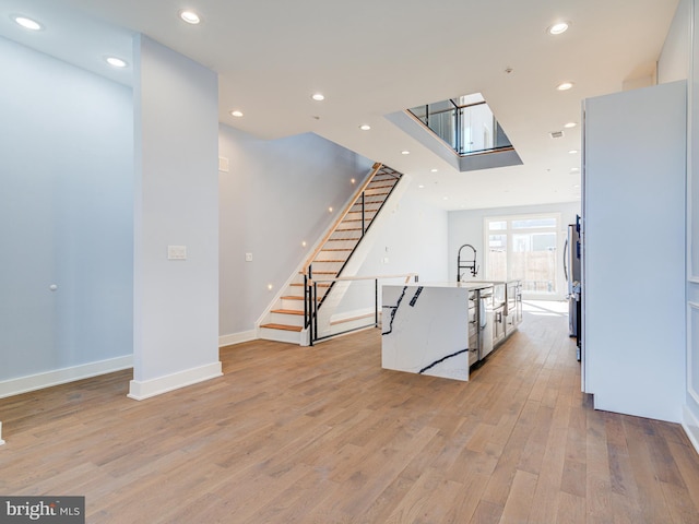 living room featuring light hardwood / wood-style floors and sink