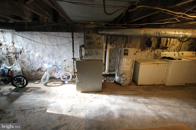 basement featuring independent washer and dryer and water heater