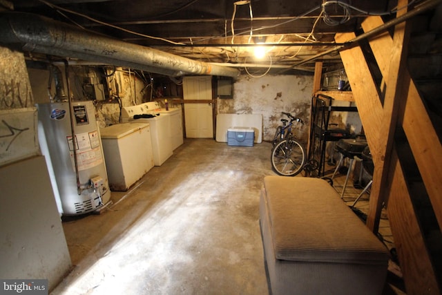 basement with water heater and washing machine and dryer