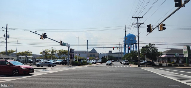 view of road with sidewalks, traffic lights, and traffic signs