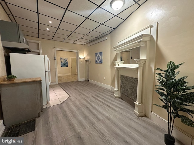 living room with a paneled ceiling and light wood-type flooring