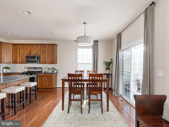 dining room featuring sink and light wood-type flooring