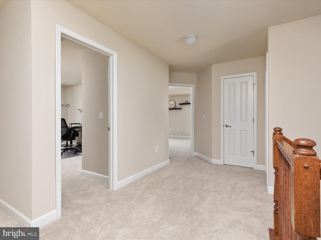 hall featuring light colored carpet