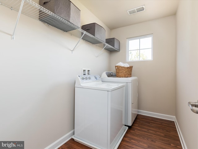 laundry room with separate washer and dryer and dark hardwood / wood-style floors