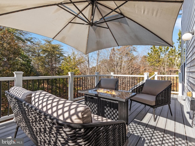 wooden terrace with an outdoor fire pit