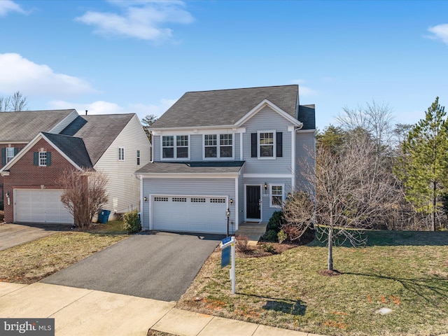 view of property with a garage and a front yard