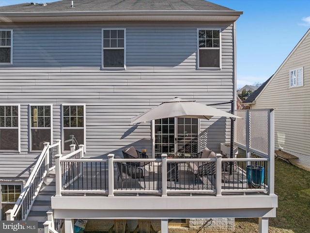 rear view of property featuring a wooden deck