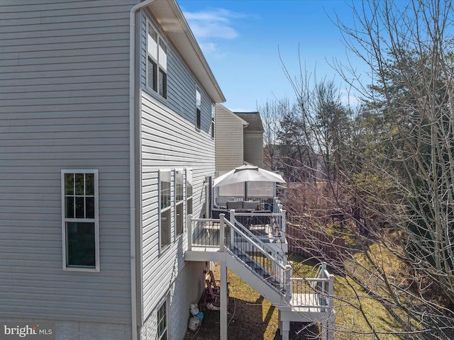 view of side of home featuring a wooden deck and a gazebo