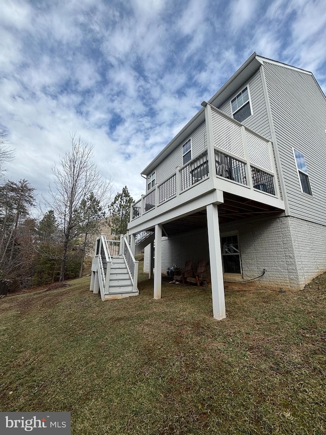 view of property exterior with a wooden deck and a yard