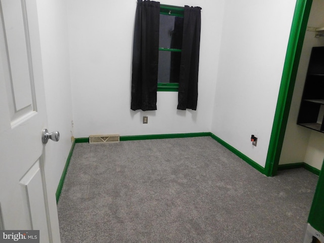 spare room featuring baseboards, visible vents, and carpet flooring