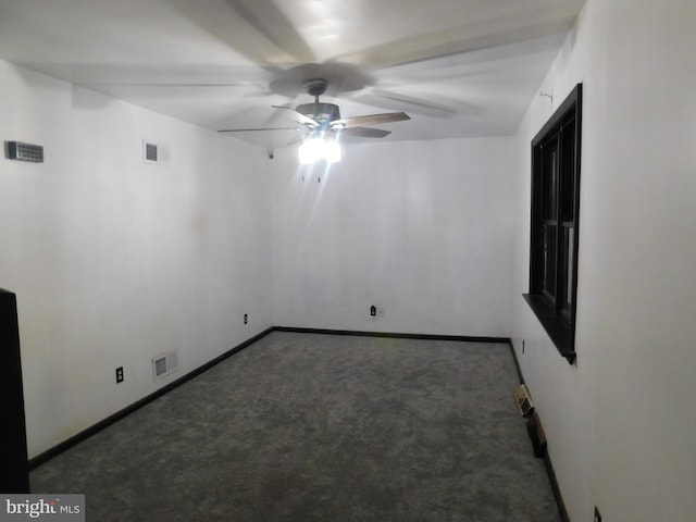 spare room featuring carpet, visible vents, and baseboards