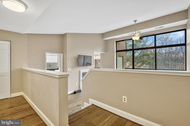 stairway featuring hardwood / wood-style flooring and vaulted ceiling