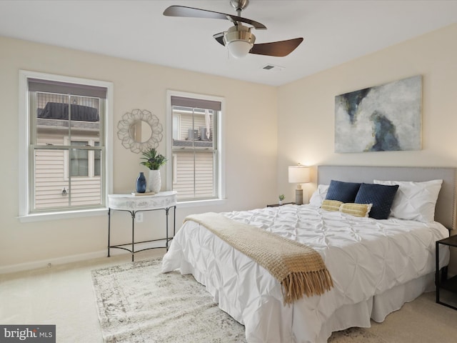 bedroom featuring a ceiling fan, baseboards, visible vents, and carpet floors