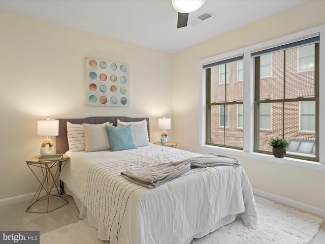 bedroom featuring visible vents, carpet flooring, a ceiling fan, and baseboards