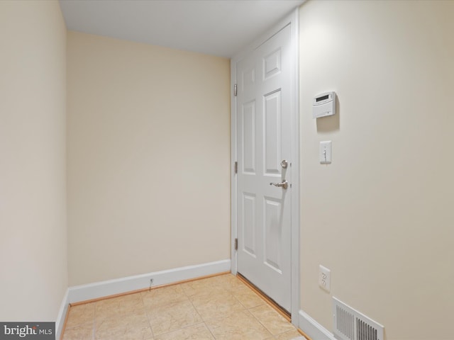 interior space featuring light tile patterned floors, baseboards, and visible vents