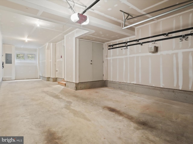 garage featuring electric panel and a garage door opener