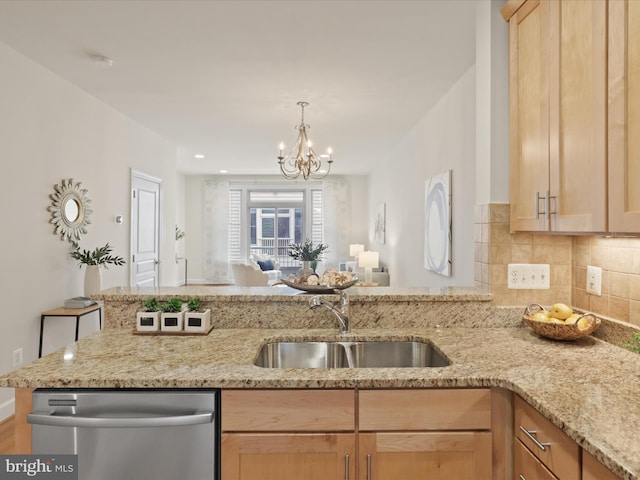 kitchen with a sink, light brown cabinets, decorative backsplash, and stainless steel dishwasher