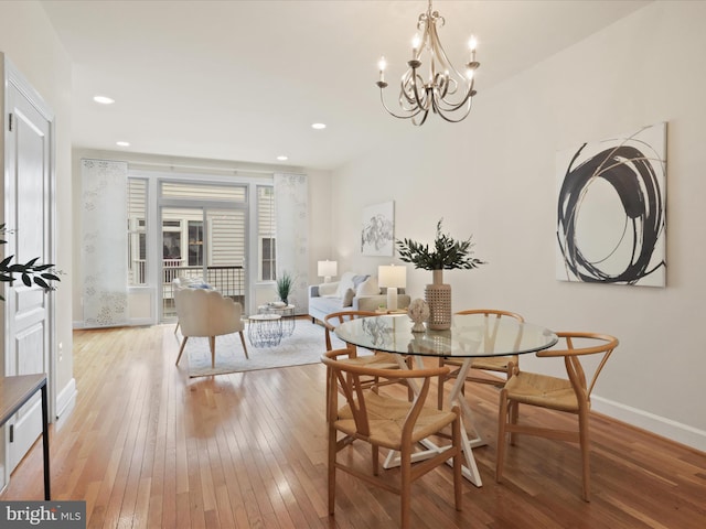 dining space featuring an inviting chandelier, recessed lighting, baseboards, and light wood-type flooring