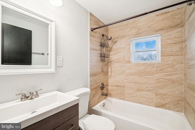 full bathroom with tiled shower / bath, vanity, and toilet