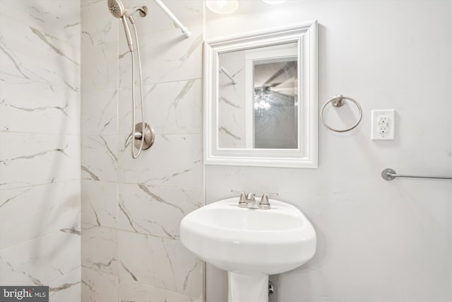 bathroom featuring sink and a tile shower