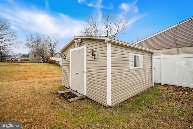 view of outbuilding featuring a lawn