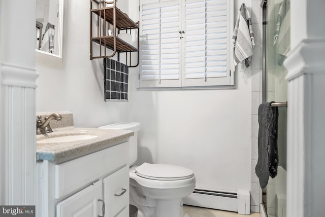 bathroom with vanity, an enclosed shower, toilet, and baseboard heating