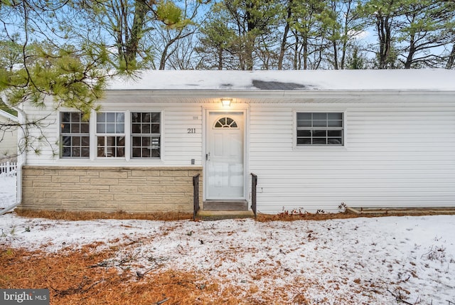 view of snow covered property entrance