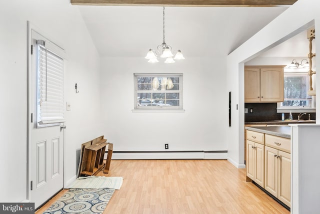 kitchen with pendant lighting, light brown cabinetry, a notable chandelier, baseboard heating, and light hardwood / wood-style floors