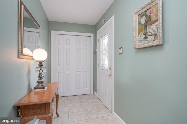 entrance foyer with baseboards and light tile patterned flooring