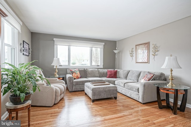 living room featuring light wood-type flooring and baseboards