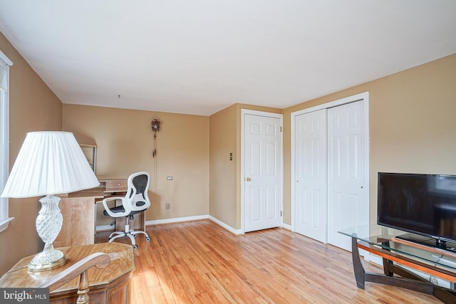 office area with light wood-type flooring and baseboards